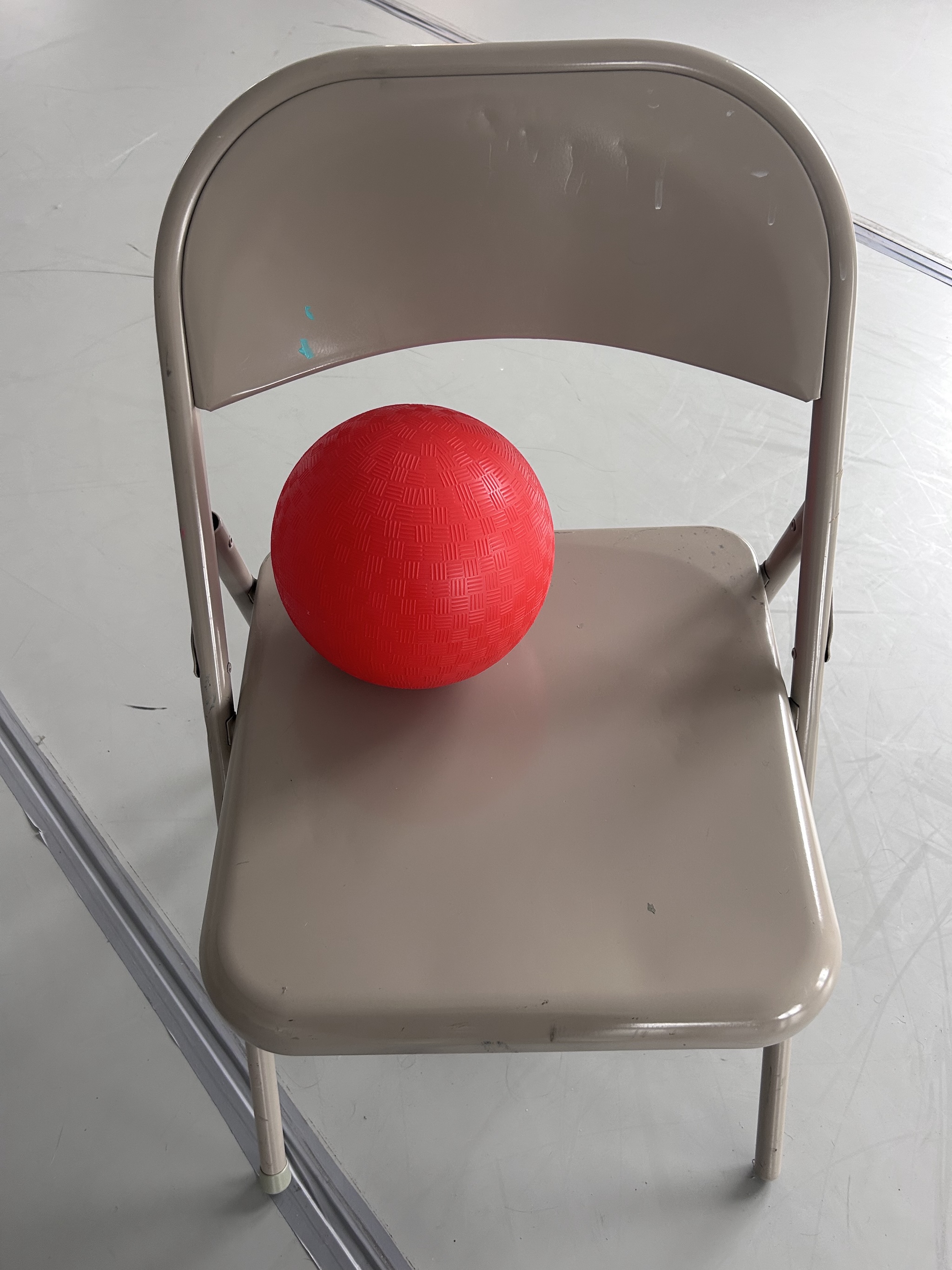 A red ball on a folding chair